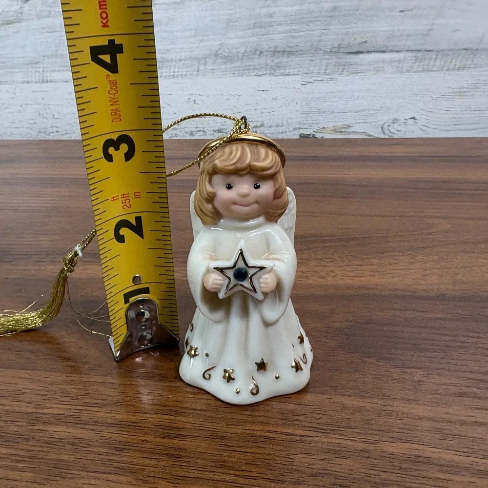 Lenox May birthstone Porcelain Angel Ornament features a hand-painted gold halo